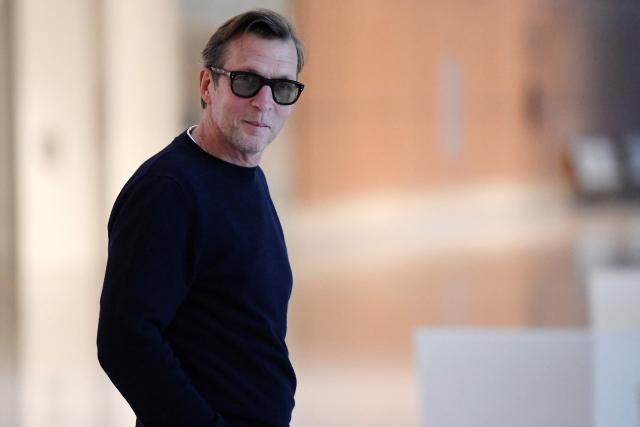 (FILES) French businessman and author Christophe Rocancourt leaves Paris' courthouse, on September 19, 2022, as part of the hearing of the so-called "36 quai des orfevres leaks" in which he faces charges, along with 18 others, for his alleged role regarding major leaks that occured within Paris' judicial police headquarters. The appeal hearing for the so-called "36 quai des orfevres leaks" case will start at the Paris Courthouse on September 21, 2026. (Photo by JULIEN DE ROSA / AFP)