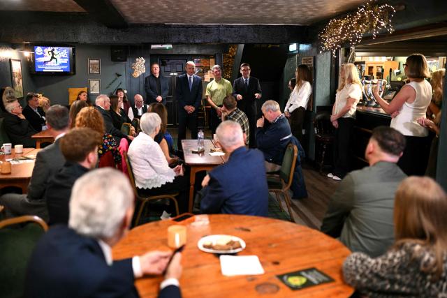 Britain's Prime Minister Andy Burnham (R) speaks alongside Ireland's Prime Minister Micheal Martin during a visit to the Brian Boru Irish Club in, Ashton-in-Makerfield, northern England, on September 18, 2026. (Photo by Oli SCARFF / POOL / AFP)