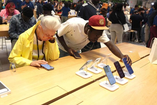 Customers attend iPhone launch day at the Apple Fifth Avenue store in New York City on September 18, 2026, for the debut of the iPhone 18 Pro and iPhone 18 Pro Max. (Photo by TIMOTHY A. CLARY / AFP)
