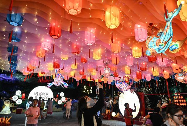 People visit a lantern festival to mark the beginning of the autumn season in Beijing on September 18, 2026. (Photo by ADEK BERRY / AFP)