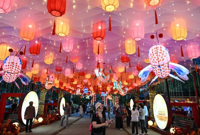 People visit a lantern festival to mark the beginning of the autumn season in Beijing on September 18, 2026. (Photo by ADEK BERRY / AFP)