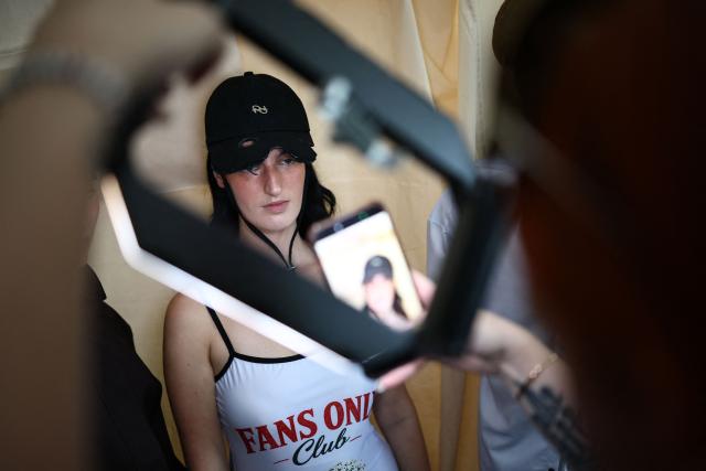 Models are prepared backstage before presenting creations from designer Ray Chu for their Spring/Summer 2027 collection on the second day of London Fashion Week, in London on September 18, 2026. (Photo by Henry NICHOLLS / AFP)