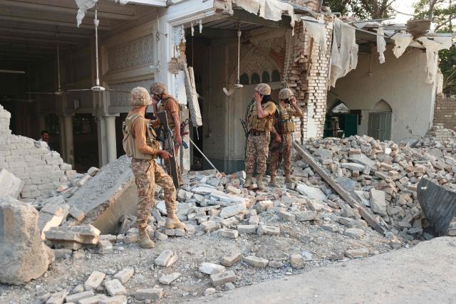 Army personnel stand amid the rubble following an explosion inside the police headquarters at Kohat in Pakistan's Khyber Pakhtunkhwa province on September 18, 2026. An explosion at a historic police headquarters in northern Pakistan on September 18 killed at least eight people and wounded 35 more, officials said, with the country's president swiftly blaming a militant group. (Photo by Basit SHAH / AFP)