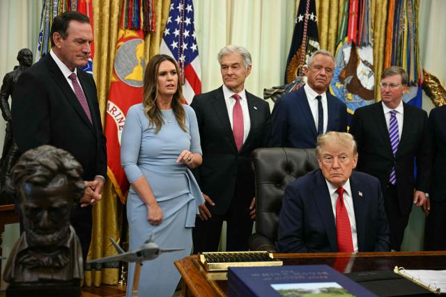 US President Donald Trump listens to Arkansas Governor Sarah Huckabee Sanders speak in the Oval Office of the White House in Washington, DC, on September 18, 2026. (Photo by Jim WATSON / AFP)
