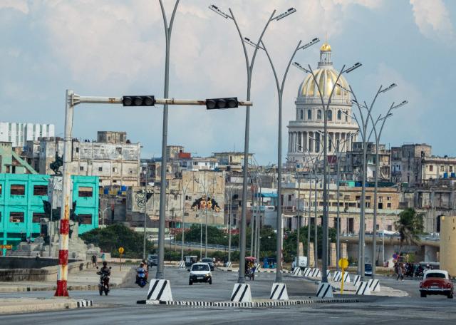 Cars drive along a road with traffic lights out during a power outage in Havana on September 18, 2026. Cuba was plunged into its seventh massive blackout of the year on September 18, 2026, the energy ministry said, as fuel shortages bite on the US-blockaded island. (Photo by ADALBERTO ROQUE / AFP)