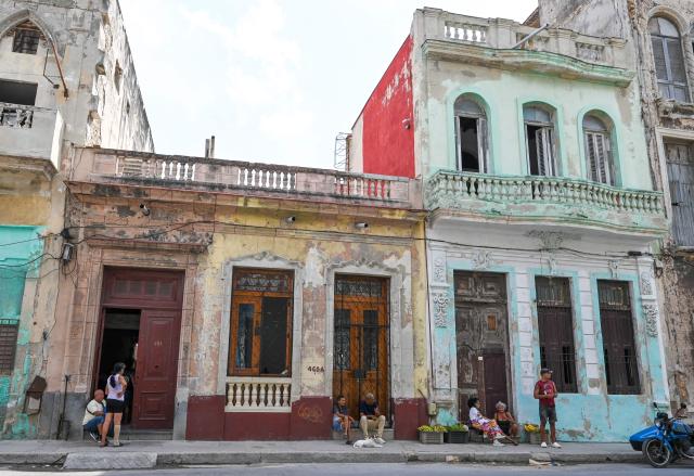 People gather on the street in front of their houses during a blackout in Havana on September 18, 2026. Cuba was plunged into its seventh massive blackout of the year on September 18, 2026, the energy ministry said, as fuel shortages bite on the US-blockaded island. (Photo by ADALBERTO ROQUE / AFP)