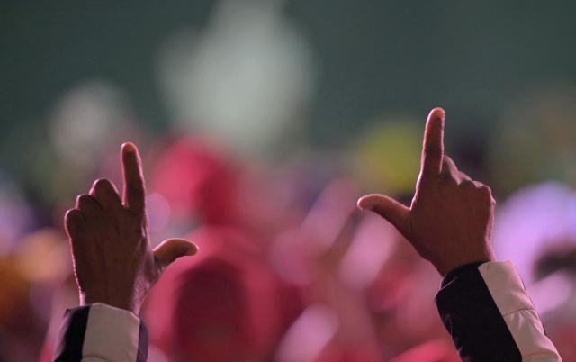 Supporters of Brazil’s President and presidential candidate Luiz Inacio Lula da Silva show an ‘L’ with their hands — for L de Lula — during a campaign rally in Guarulhos, in the metropolitan area of Sao Paulo, Brazil on September 18, 2026. Brazil will hold a presidential election on October 4 2026. (Photo by NELSON ALMEIDA / AFP)