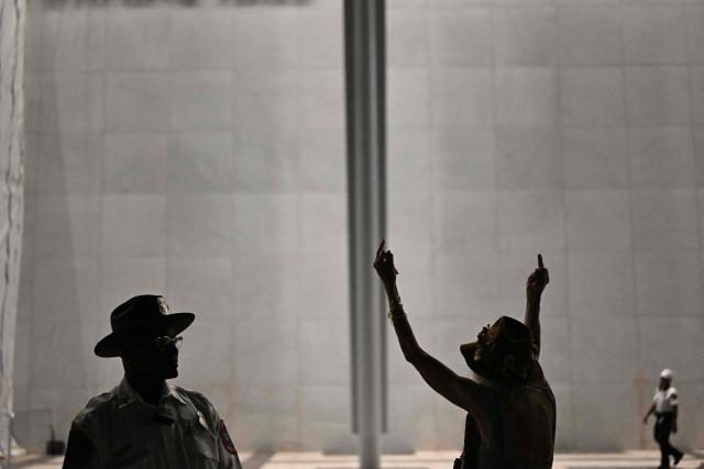 A person gives holds two middle fingers up during a rally in support of the Kennedy Center in Washington, DC, on September 18, 2026. (Photo by Kent NISHIMURA / AFP)