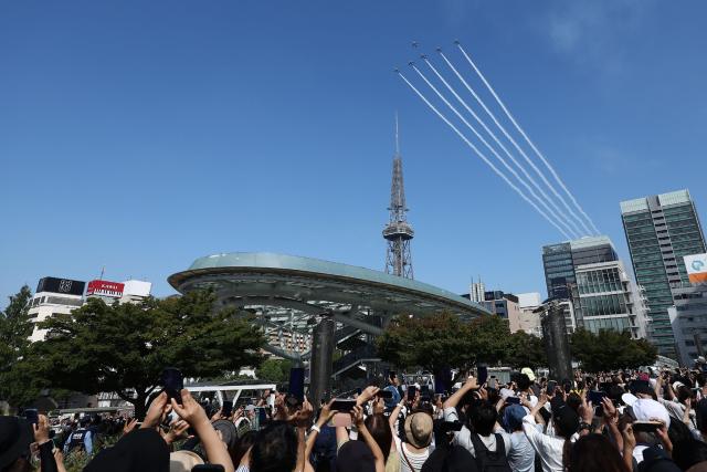 Kawasaki T-4s of the Japan Air Self-Defense Force's Blue Impulse aerobatic demonstration team perform a flypast ahead of the opening ceremony for the 2026 Asian Games in Nagoya on September 19, 2026. (Photo by JIJI Press / AFP) / Japan OUT