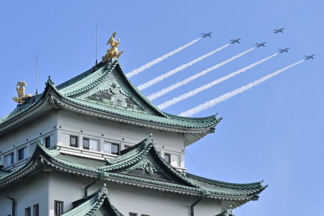 Kawasaki T-4s of the Japan Air Self-Defense Force's Blue Impulse aerobatic demonstration team perform a flypast near Nagoya Castle ahead of the opening ceremony for the 2026 Asian Games in Nagoya on September 19, 2026. (Photo by JIJI Press / AFP) / Japan OUT