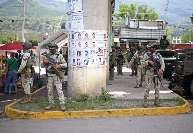 Army officers stand guard on a street in Quechultenango, Guerrero state, Mexico on September 18, 2026. Residents of a volatile region of Mexico where criminal gangs operate, detained a group of police officers and soldiers for about four hours on September 17, 2026, AFP observed. (Photo by Eduardo Guerrero / AFP)
