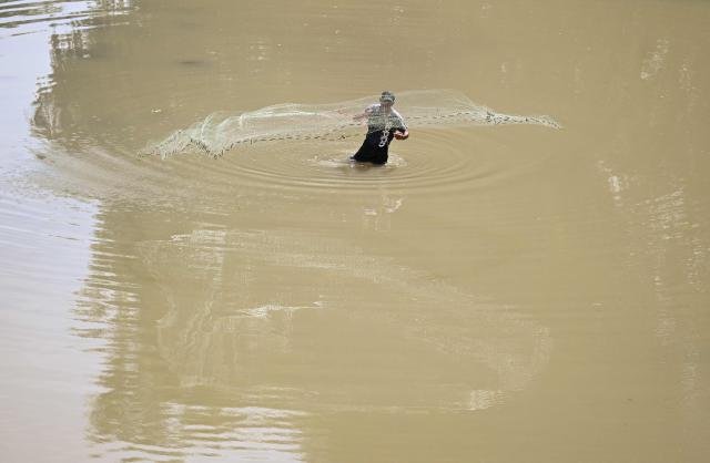 A fisherman fish on the Ostua river in Asuncion Mita, Jutiapa, Guatemala on September 18, 2026. Communities and environmental organizations from Guatemala and El Salvador called on Guatemala's Public Prosecutor's Office to permanently close the operations of Era Dorada mining project four years after a municipal consultation rejected metal mining in the municipality. (Photo by Marvin RECINOS / AFP)