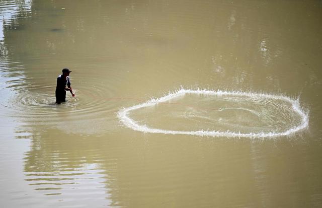 A fisherman fish on the Ostua river in Asuncion Mita, Jutiapa, Guatemala on September 18, 2026. Communities and environmental organizations from Guatemala and El Salvador called on Guatemala's Public Prosecutor's Office to permanently close the operations of Era Dorada mining project four years after a municipal consultation rejected metal mining in the municipality. (Photo by Marvin RECINOS / AFP)