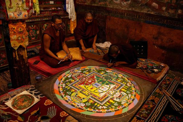 Buddhist monks create a sand mandala at the Thiksey monastery in Thiksey, in India's Ladakh region on September 19, 2026. (Photo by Mohd Arhaan ARCHER / AFP)