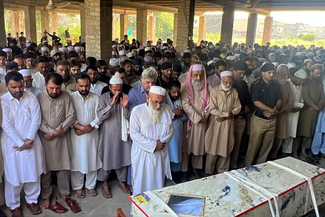 People offer funeral prayers for a policeman, a day after he was killed in an explosion inside the police headquarters at Kohat in Pakistan's Khyber Pakhtunkhwa province on September 19, 2026. The death toll from an explosion and gun attack at a police headquarters in northern Pakistan rose to at least 31, including 16 police personnel, a senior police official told AFP on September 19, with fighting ongoing. (Photo by Aftab Ahmad KHAN / AFP)