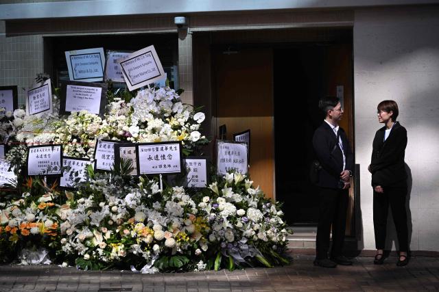 Funeral home staff are seen as mourners arrive to pay respects to Tung Chee-hwa, Hong Kong's first leader after the city's return to Chinese rule, at North Point Funeral Home in Hong Kong on September 19, 2026. Tung, who died on September 8, was a divisive figure, with Chinese state media hailing him as a "renowned patriot" and "close friend of the Communist Party", though some of his policies sparked widespread protests. (Photo by Peter PARKS / AFP)