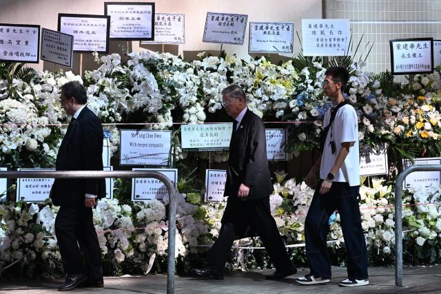 Mourners arrive to pay respects to Tung Chee-hwa, Hong Kong's first leader after the city's return to Chinese rule, at North Point Funeral Home in Hong Kong on September 19, 2026. Tung, who died on September 8, was a divisive figure, with Chinese state media hailing him as a "renowned patriot" and "close friend of the Communist Party", though some of his policies sparked widespread protests. (Photo by Peter PARKS / AFP)