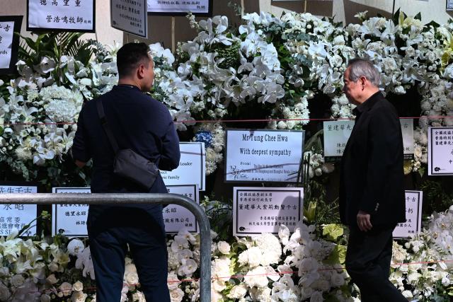 Mourners arrive to pay respects to Tung Chee-hwa, Hong Kong's first leader after the city's return to Chinese rule, at North Point Funeral Home in Hong Kong on September 19, 2026. Tung, who died on September 8, was a divisive figure, with Chinese state media hailing him as a "renowned patriot" and "close friend of the Communist Party", though some of his policies sparked widespread protests. (Photo by Peter PARKS / AFP)