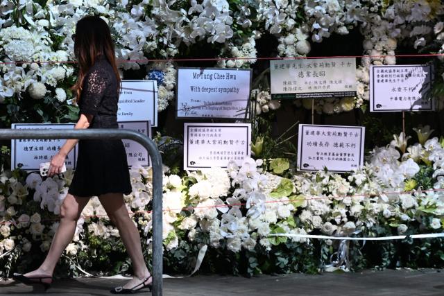 A mourner arrives to pay respects to Tung Chee-hwa, Hong Kong's first leader after the city's return to Chinese rule, at North Point Funeral Home in Hong Kong on September 19, 2026. Tung, who died on September 8, was a divisive figure, with Chinese state media hailing him as a "renowned patriot" and "close friend of the Communist Party", though some of his policies sparked widespread protests. (Photo by Peter PARKS / AFP)