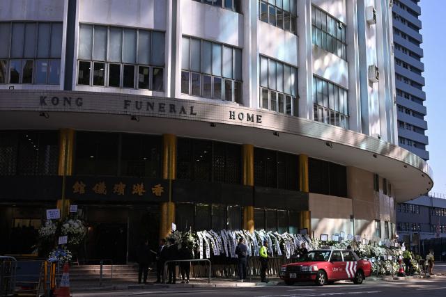 Police and security are seen as mourners arrive to pay respects to Tung Chee-hwa, Hong Kong's first leader after the city's return to Chinese rule, at North Point Funeral Home in Hong Kong on September 19, 2026. Tung, who died on September 8, was a divisive figure, with Chinese state media hailing him as a "renowned patriot" and "close friend of the Communist Party", though some of his policies sparked widespread protests. (Photo by Peter PARKS / AFP)