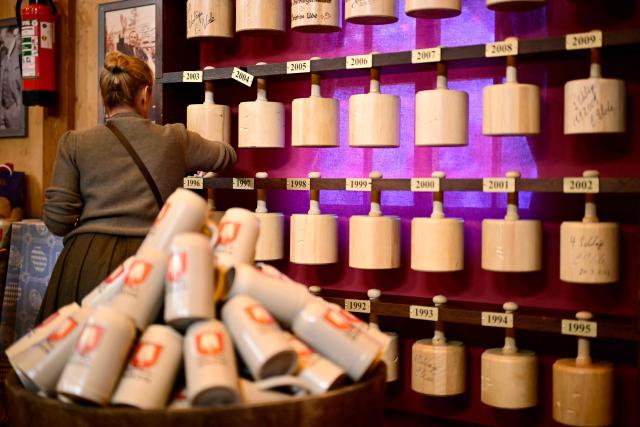 A woman cleans a collection of tapping mallets that were used by Munich mayors to open the traditional Oktoberfest beer festivals, as preparations are under way to officially open the 191st Oktoberfest beer festival in Munich, southern Germany on September 19, 2026. The world's biggest beer festival Oktoberfest runs until October 4, 2026. (Photo by Tobias SCHWARZ / AFP)