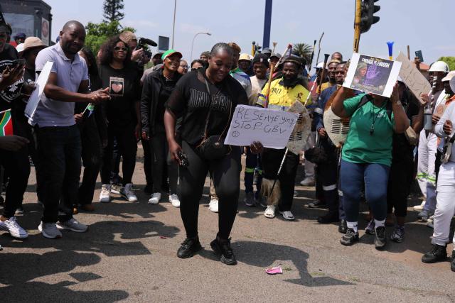 A woman holds a placard as she takes part with others during a protest march in Kempton Park on September 19, 2026 following the recent string of murders that occurred in the east of Johannesburg. South African police on September 17 recovered the body of a ninth woman east of Johannesburg in two months, as a string of murders continues to stoke public anxiety. The country has one of the world's highest homicide rates but the discovery of the women's bodies, partially naked and battered, has raised fears that a serial killer or group of killers may be operating in the area. Police have offered a 400,000 rand ($25,000) reward for any information that could lead to the arrest of the killer or killers, while the Democratic Alliance, the second largest political party in South Africa offered $31,000. (Photo by MZINGENKOSI SIBANDA / AFP)