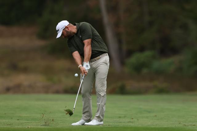 England's Jordan Smith plays his approach shot from the 16th fairway on day three of the BMW PGA Championship at Wentworth Golf Club in the town of Virginia Water in Surrey, southwest of London, on September 19, 2026. (Photo by Adrian DENNIS / AFP)