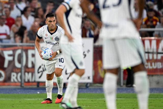 Inter Milan's Argentinian forward #10 Lautaro Martinez (L) carries the ball as he celebrates after scoring during the Italian Serie A football match between AS Roma and Inter Milan at The Olympic Stadium in Rome on September 19, 2026. (Photo by Andreas SOLARO / AFP)