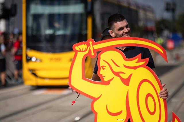 A member of the Slovakian team from Bratislava is setting up a cardboard figure of the Warsaw Mermaid – the symbol of the town – during an competition focused on precisely avoiding obstacles during the 12th European Tram Driver Championship in front of Palace of Culture and Science on Marszalkowska street in Warsaw's downtown, on September 19, 2026. 26 teams – each consisting of a female and a male tram driver, from 25 cities and 24 European countries, plus one guest team from Melbourne, Australia – show off their driving skills in a series of challenging competitions that test their precision, concentration, feel for the vehicle, and control of the tram. (Photo by Wojtek RADWANSKI / AFP)
