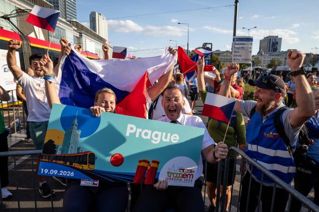 Members of Czech Republic's team from Prague, Vendula Tmejova (L) and Zdenek Rychtar (R), celebrate after winning the 12th European Tram Driver Championship in front of the Palace of Culture and Science on Marszalkowska Street in downtown Warsaw, on September 19, 2026. 26 teams – each consisting of a female and a male tram driver, from 25 cities and 24 European countries, plus one guest team from Melbourne, Australia – show off their driving skills in a series of challenging competitions that test their precision, concentration, feel for the vehicle, and control of the tram. (Photo by Wojtek RADWANSKI / AFP)
