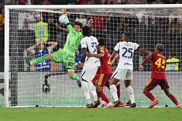 Roma's Serbian goalkeeper #99 Mile Svilar (L) saves a goal during the Italian Serie A football match between AS Roma and Inter Milan at The Olympic Stadium in Rome on September 19, 2026. (Photo by Andreas SOLARO / AFP)