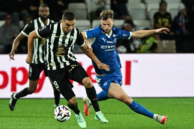 Angers's Moroccan forward #19 Amine El Ouazzani fights for the ball with Troyes' French forward #09 Jeremy Le Douaron during the French L1 football match between SCO Angers and ES Troyes AC at the Stade Raymond-Kopa in Angers on September 19, 2026. (Photo by Sebastien Salom-Gomis / AFP)