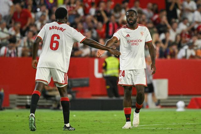 Sevilla's French midfielder #24 Youssouf Fofana celebrates with teammate French midfielder #06 Lucien Agoume after scoring a goal during the Spanish league football match between Sevilla FC and FC Barcelona at the Ramon Sanchez Pizjuan stadium in Seville on September 19, 2026 (Photo by JORGE GUERRERO / AFP)