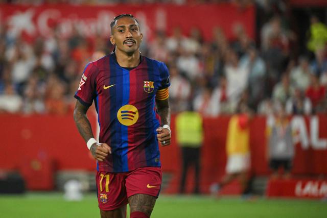 Barcelona's Brazilian forward #11 Raphinha celebrates scoring his team's second goal during the Spanish league football match between Sevilla FC and FC Barcelona at the Ramon Sanchez Pizjuan stadium in Seville on September 19, 2026. (Photo by JORGE GUERRERO / AFP)