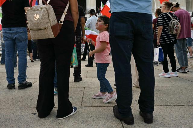 People participate in a rally in support of human rights and equality for women in Iran in Washington, DC on September 19, 2026. Several months of protests against the Islamic republic's theocratic authorities known as the "Woman. Life. Freedom." movement erupted in September 2022 following the custody death of Iranian Kurdish woman Mahsa Amini who had been arrested for allegedly violating the strict dress rules for women. (Photo by Jim WATSON / AFP)