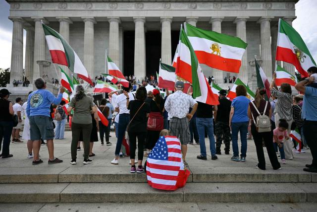People participate in a rally in support of human rights and equality for women in Iran by the Lincoln Memorial in Washington, DC on September 19, 2026. Several months of protests against the Islamic republic's theocratic authorities known as the "Woman. Life. Freedom." movement erupted in September 2022 following the custody death of Iranian Kurdish woman Mahsa Amini who had been arrested for allegedly violating the strict dress rules for women. (Photo by Jim WATSON / AFP)