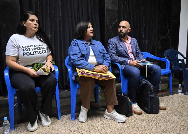 The head of Venezuela's opposition delegation, Dinorah Figuera (C), and other delegation members meet with relatives of political prisoners in Caracas on September 19, 2026. (Photo by Juan BARRETO / AFP)