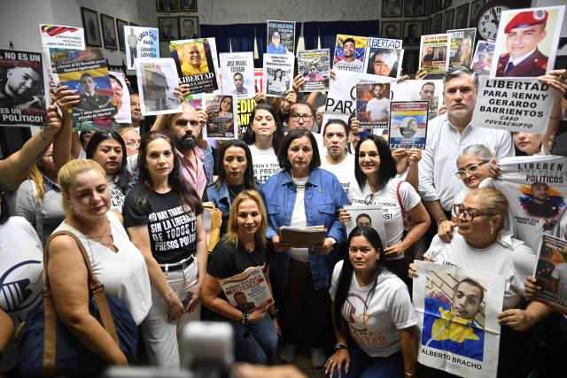 The head of Venezuela's opposition delegation, Dinorah Figuera (C), and other delegation members meet with relatives of political prisoners in Caracas on September 19, 2026. (Photo by Juan BARRETO / AFP)