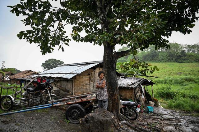 This photo taken on September 2, 2026, shows a resident standing outside her house in Capas, Tarlac province. In April, the United States announced that the Philippines had joined Pax Silica, a US-led effort to strengthen supply chains for semiconductors and rare earth elements and reduce participating countries' dependence on China. (Photo by Jam STA ROSA / AFP) / TO GO WITH AFP STORY: Philippines-US-China-AI-technology, FOCUS by Pam Castro and Chad WILLIAMS