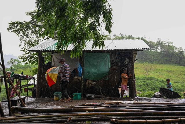 This photo taken on September 2, 2026, shows residents standing at their home in Capas, Tarlac province. In April, the United States announced that the Philippines had joined Pax Silica, a US-led effort to strengthen supply chains for semiconductors and rare earth elements and reduce participating countries' dependence on China. (Photo by Jam STA ROSA / AFP) / TO GO WITH AFP STORY: Philippines-US-China-AI-technology, FOCUS by Pam Castro and Chad WILLIAMS