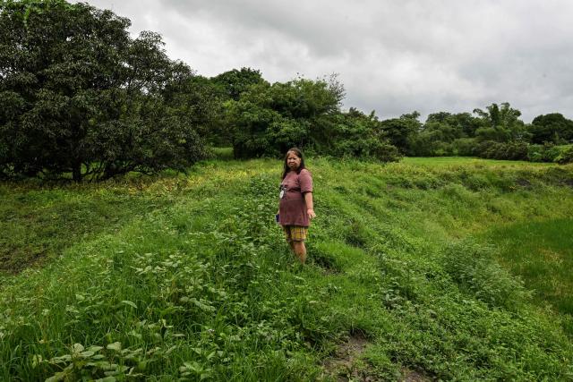 This photo taken on August 10, 2026, shows a resident standing on the land where Pax Silica hub might be built in Capas, Tarlac province. In April, the United States announced that the Philippines had joined Pax Silica, a US-led effort to strengthen supply chains for semiconductors and rare earth elements and reduce participating countries' dependence on China. (Photo by Jam STA ROSA / AFP) / TO GO WITH AFP STORY: Philippines-US-China-AI-technology, FOCUS by Pam Castro and Chad WILLIAMS