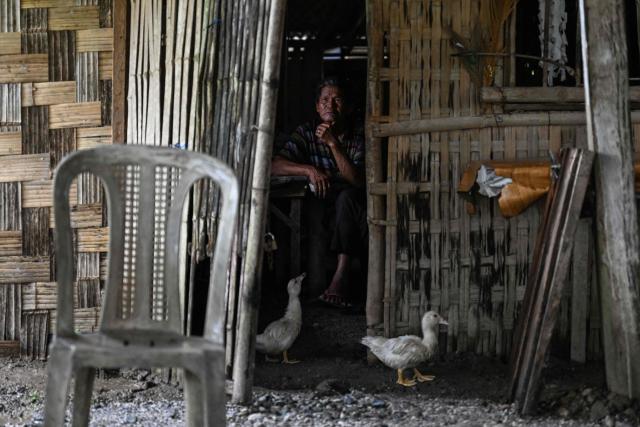 This photo taken on September 2, 2026, shows a resident sitting inside a hut in Capas, Tarlac province. In April, the United States announced that the Philippines had joined Pax Silica, a US-led effort to strengthen supply chains for semiconductors and rare earth elements and reduce participating countries' dependence on China. (Photo by Jam STA ROSA / AFP) / TO GO WITH AFP STORY: Philippines-US-China-AI-technology, FOCUS by Pam Castro and Chad WILLIAMS
