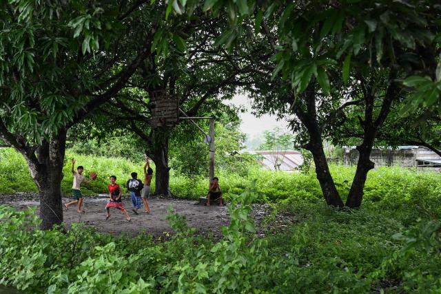 This photo taken on August 10, 2026, shows children playing basketball in Capas, Tarlac province. In April, the United States announced that the Philippines had joined Pax Silica, a US-led effort to strengthen supply chains for semiconductors and rare earth elements and reduce participating countries' dependence on China. (Photo by Jam STA ROSA / AFP) / TO GO WITH AFP STORY: Philippines-US-China-AI-technology, FOCUS by Pam Castro and Chad WILLIAMS