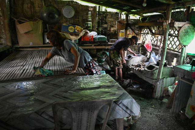 This photo taken on September 2, 2026, shows Petronila Munoz (L), a Filipino chieftain, working inside her house in Capas, Tarlac province. In April, the United States announced that the Philippines had joined Pax Silica, a US-led effort to strengthen supply chains for semiconductors and rare earth elements and reduce participating countries' dependence on China. (Photo by Jam STA ROSA / AFP) / TO GO WITH AFP STORY: Philippines-US-China-AI-technology, FOCUS by Pam Castro and Chad WILLIAMS