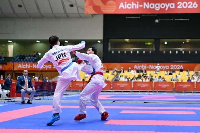 Japan's Hashimoto Hiromu (L) and Jordan's Abdallah Hammad compete in the men's kumite -60kg karate bout during the 2026 Asian Games at the Toyohashi Gymnasium in Toyohashi, Aichi prefecture on September 20, 2026. (Photo by MOHD RASFAN / AFP)