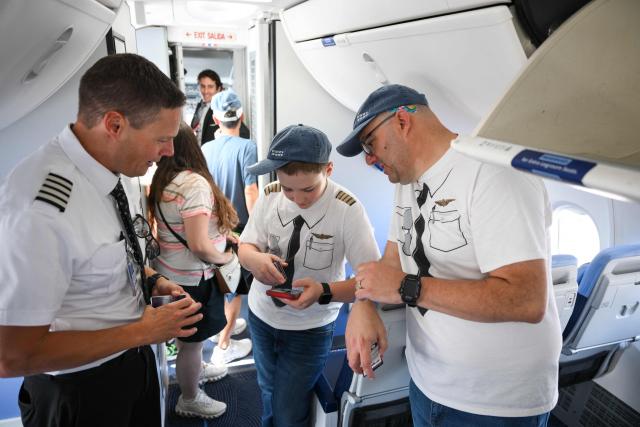 Attendees speak with a pilot (L) inside the cabin of the Southwest Airlines “Independence One” Boeing 737 MAX 8 (N1776R) aircraft in America 250th livery as aviation enthusiasts gather for the Cranky Dorkfest 2026 event at Los Angeles International Airport (LAX) in Los Angeles, on September 19, 2026. (Photo by Patrick T. Fallon / AFP)