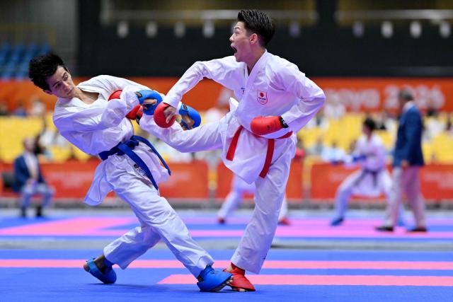 Japan's Hashimoto Hiromu (R) and Tajikistan's Muhammad Mirzozoda compete in the men's kumite -60kg karate bout during the 2026 Asian Games at the Toyohashi Gymnasium in Toyohashi, Aichi prefecture on September 20, 2026. (Photo by MOHD RASFAN / AFP)