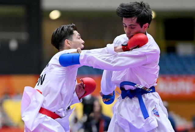 Japan's Hashimoto Hiromu (L) and Tajikistan's Muhammad Mirzozoda compete in the men's kumite -60kg karate bout during the 2026 Asian Games at the Toyohashi Gymnasium in Toyohashi, Aichi prefecture on September 20, 2026. (Photo by MOHD RASFAN / AFP)