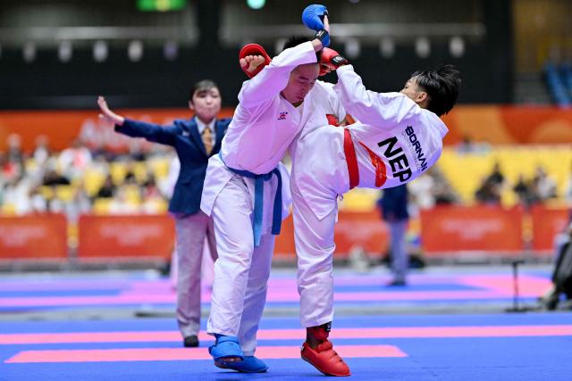 Nepal's Min Bahadur Tamang (R) and Hong Kong's Chau Ka Him compete in the men's kumite -60kg karate bout during the 2026 Asian Games at the Toyohashi Gymnasium in Toyohashi, Aichi prefecture on September 20, 2026. (Photo by MOHD RASFAN / AFP)