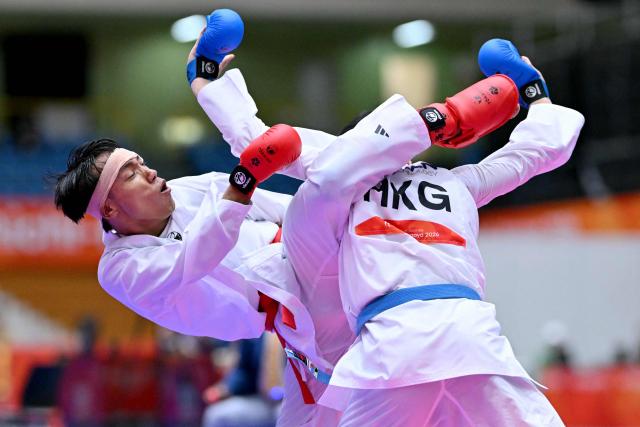 Nepal's Min Bahadur Tamang (L) and Hong Kong's Chau Ka Him compete in the men's kumite -60kg karate bout during the 2026 Asian Games at the Toyohashi Gymnasium in Toyohashi, Aichi prefecture on September 20, 2026. (Photo by MOHD RASFAN / AFP)